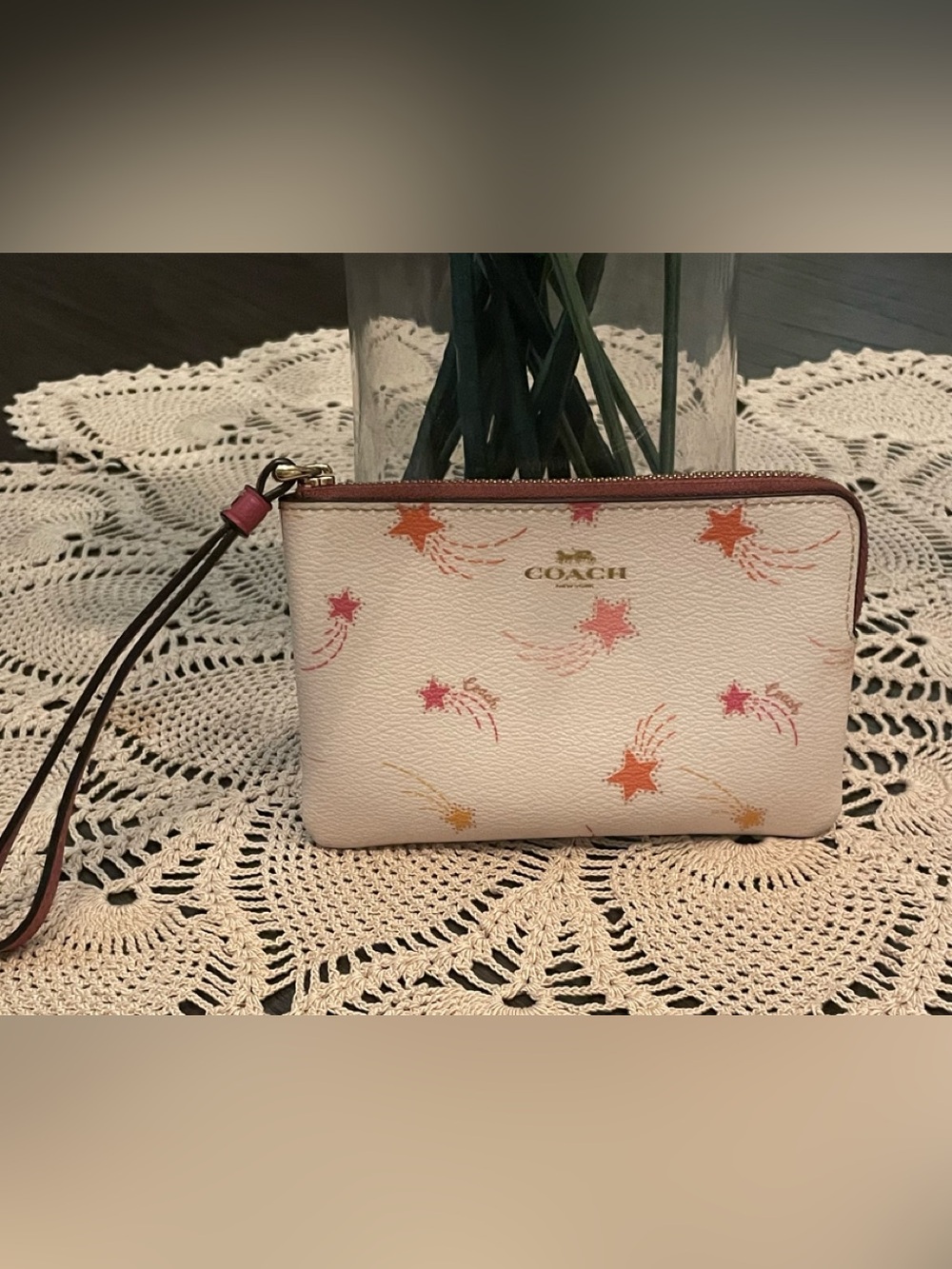 Coach Corner Zip Wristlet features a playful shooting star print